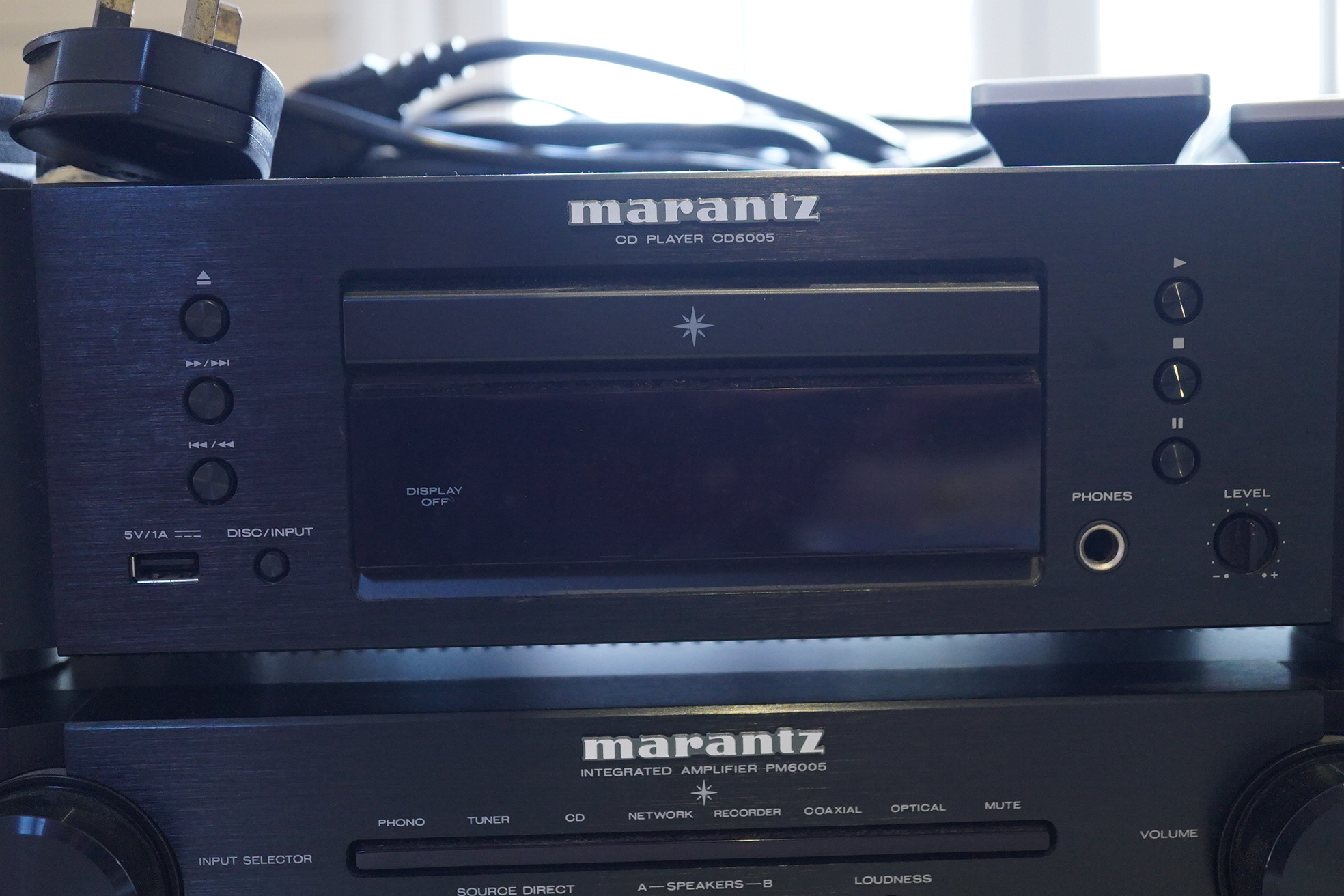 A Marantz HiFi integrated amplifier PM6005, together with a CD player CD6005, plus two remote controls and power leads